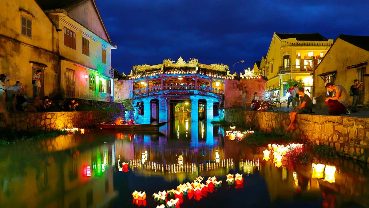 Flower lanterns floating on the river in front of the Japanese Covered Bridge at dusk