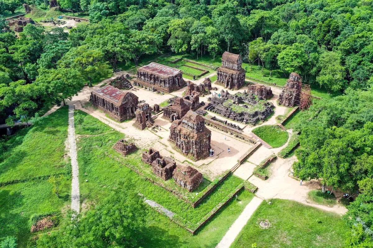 Red-brick Cham temple towers in a clearing surrounded by forest at My Son, seen from above