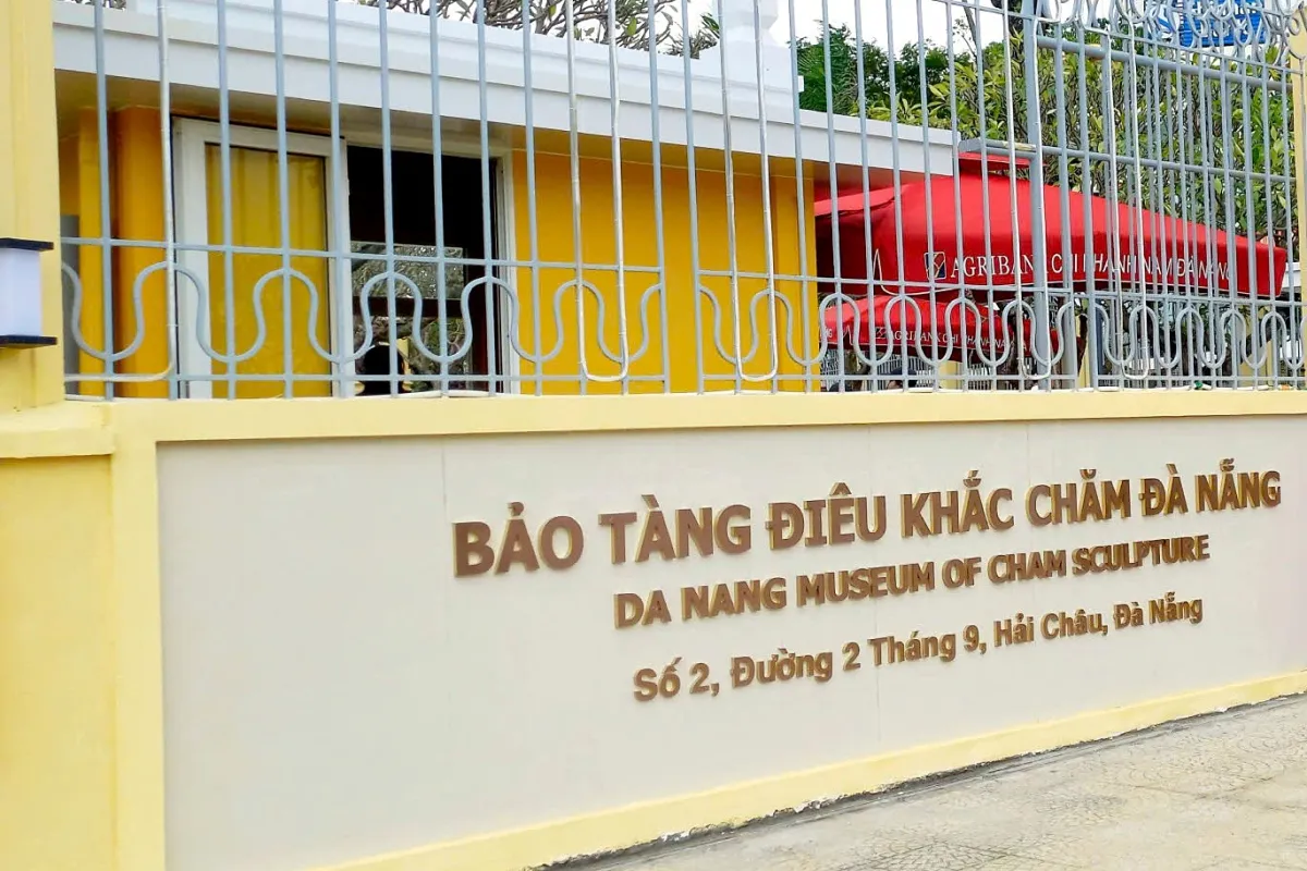 Yellow wall and ornamental iron fence with the museum's name in Vietnamese and English and its street address